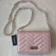 Bebe Sophia Crossbody Quilted Handbag with Chain Strap. Color: Blush. Crossbody strap with chain detail. Quilted design. 44.5” strap fully extended. Gold tone hardware. 1 interior zip pocket. 1 interior slip pocket. Cross Over Purse, Pink Crossbody Evening Bag With Chain Strap, Chic Pink Evening Bag With Chain Strap, Chic Pink Wallet On Chain With Chain Strap, Feminine Shoulder Bag With Chain Strap, Pink Evening Wallet On Chain With Chain Strap, Rectangular Pink Wallet On Chain For Evening, Chic Pink Clutch With Chain Strap, Elegant Pink Wallet On Chain With Strap