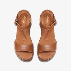 WOMENS Kassanda Lily Tan Leather Wedges | Clarks US Closed Toe Wedge Sandals With Cork-bed Midsoles, Casual Cork Wedge Heel Sandals, Casual Cork Wedge Sandals Open Toe, Casual Open Toe Cork Wedge Sandals, Brown Sandals With Cork-bed Midsoles, Cork Open Toe Sandals, Casual Cork Wedge Sandals With Leather Footbed, Shoe Care Kit, Low Wedge Sandals