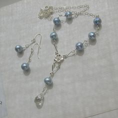 This is a very fresh looking, kind of "youngish girlish" jewelry set with an art deco touch, consisting of earrings and necklace with a long Y- pendant-part. The Freshwater pearls are oval / slightly baroque in shape and measure approx. 7 mm x 8 to 9 mm in size, individually wire-wrapped.  They are color enhanced to a light blue / baby blue color, with very good luster, some small growth marks, lines of development and color variations. Each pearl is a little bit different in shape, but matched Crystal Quartz Earrings, Baby Blue Colour, Pearl Set, Floral Bridal, Quartz Earrings, Bridal Pearls, Hibiscus Flowers, Crystal Quartz, Rock Crystal