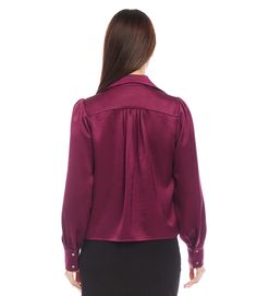 This Shirred Blouse features elegant puff sleeves and a soft, satin fabric. The delicate shirring adds a touch of sophistication, while the shell buttons provide a timeless finishing touch. Perfect for a professional look or a special occasion. Recycled Satin: 55% Polyester 45% Recycled Polyester Made in the USA of Imported Fabric Length: 23 5/8 inches (size M) Dry Clean Only Button front closure Sleeves with cuffs Notch Collared Peasant sleeves with Shell buttons | Karen Kane Shirred Satin Blou Shirred Blouse, Peasant Sleeve, Karen Kane, Shell Buttons, Satin Blouse, Professional Look, Satin Fabric, Puff Sleeves, Puff Sleeve