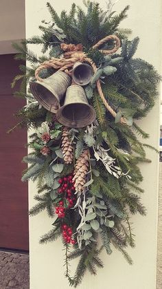 a christmas wreath with bells and evergreens