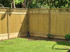 a wooden fence in the middle of a yard