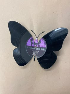 a butterfly shaped vinyl record with the words flesh life on it's back side