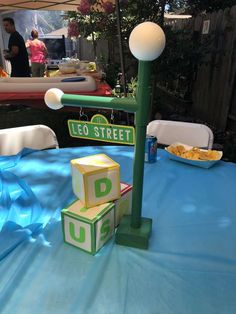 a table that has some blocks on it and a street sign in the middle of it