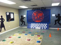 an office decorated with various silhouettes of people and words on the wall, including letters that spell out