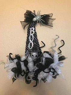 a black and white halloween decoration hanging on the wall