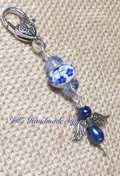 a blue and white glass beaded charm on a silver plated keychain