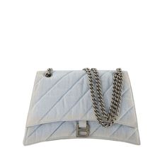 This shoulder bag features a quilted denim exterior and a magnetic flap closure for secure storage. The chain strap allows for easy wear on the shoulder, making it a stylish option for different occasions.

- Quilted denim exterior
- Magnetic flap closure
- Chain strap for shoulder wear Balenciaga Handbags, Denim Quilt, Stylish Shoulder Bag, Shoulder Chain, Denim Blue, Birkin Bag, Gucci Jackie Bag, Dior Saddle Bag, Hermes Bag Birkin