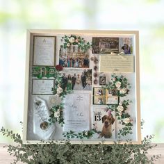 a wooden frame with pictures and flowers on it