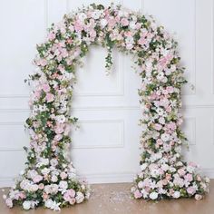 two floral archways with pink and white flowers