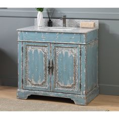 an old blue cabinet with a sink in it