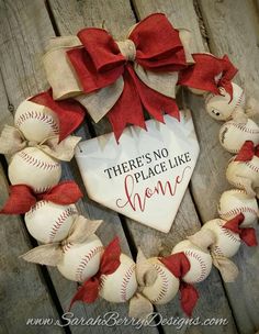 there's no place like home wreath with baseballs and red bows on it