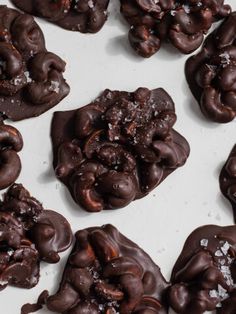 chocolate covered cookies are on a white surface