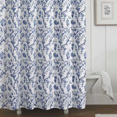 a blue and white shower curtain in a bathroom