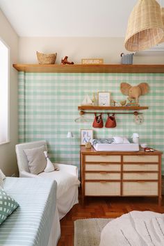 a baby's room with green and white checkered wallpaper, two twin beds in the foreground