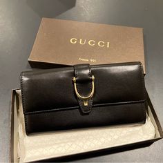 Gucci Wallet. Never Used. Button Clasp. Plenty Of Card Space. And Multiple Bill Compartments. Authentication Card Included. Elegant Bifold Wallet For Office, Designer Gucci Wallets With Gold-tone Hardware, Gucci Bifold Wallet For Formal Occasions, Classic Gucci Wallets With Gold-tone Hardware, Classic Gucci Wallet With Gold-tone Hardware, Gucci Bifold Evening Wallet, Gucci Black Wallet For Formal Occasion, Gucci Designer Wallet For Formal Occasions, Elegant Gucci Bifold Wallet