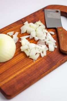 chopped onions and a knife on a cutting board