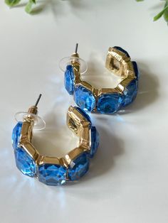 Elevate your style with Laura Hoop Earrings. The beautiful blue hoops and baguette shaped jewels give these earrings a unique and sophisticated look. The chunkier style provides a modern twist to a classic accessory, making it perfect for any occasion. Elevate your style with Laura Hoop Earrings. Perfect for Rush week for Sorority! Stud post Approx. 1" diameter Blue Hoop Earrings For Party, Modern Small Blue Hoop Earrings, Trendy Blue Crystal Earrings For Party, Trendy Small Blue Hoop Earrings, Trendy Blue Small Hoop Earrings, Blue Metal Hoop Earrings, Rush Week, Vintage Soul, Sophisticated Look