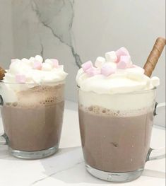 two cups filled with hot chocolate and marshmallows