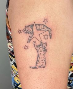 a woman with a cat tattoo on her arm and the star is in the sky