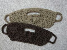 two crocheted purses sitting on top of a white towel next to each other