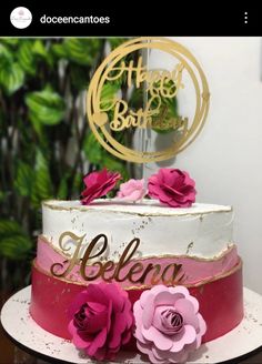 a white and pink cake with flowers on the top that says hello baby, belenu