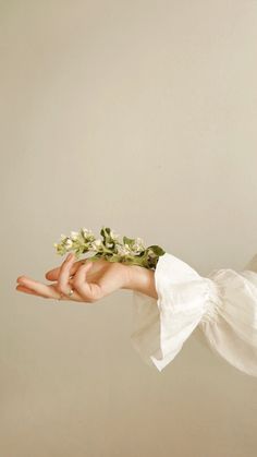 a woman holding flowers in her hand