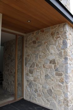 an outside view of a house with stone walls