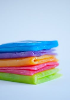 five different colored soap bars stacked on top of each other in the shape of rainbows