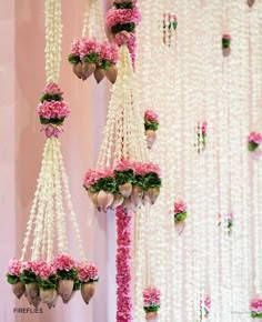 pink and white flowers hanging from the ceiling