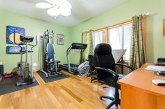 a home gym with exercise equipment in the corner