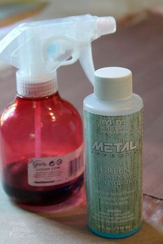 a close up of a bottle of cleaner next to a sprayer on a table