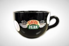 a black coffee cup with the words central perk on it