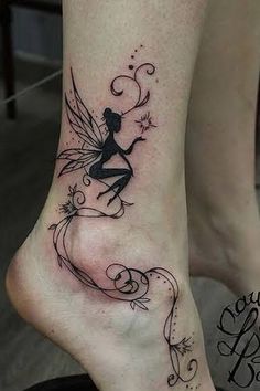 a woman's foot with a fairy tattoo on the top and bottom of it