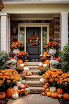 a front porch with pumpkins and gourds on the steps