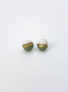 Minimalist design meets a feminine casual elegance. Equal parts sleek and sweet, you can wear this versatile pair of button studs with both dressy and casual outfits. A handcrafted but affordable indulgence, these earrings are great for gifting, too.A swath of jade green glaze exudes a soft warmth, while a thin band of gold-toned porcelain paint adds a modern touch. The posts and backings are nickel-free. As the earrings are handmade, each is unique; expect individual variations. For a set, see Porcelain Paint, Feminine Casual, Button Studs, Jewelry Gift Ideas, Versatile Jewelry, Handmade Porcelain, Handmade Jewelry Gift, Button Earrings, Green Button