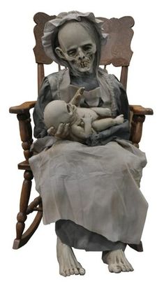 a skeleton sitting in a rocking chair with a baby doll on it's lap