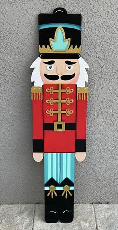 a wooden nutcracker is hanging on the wall