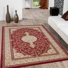 a living room with a large red rug on the floor