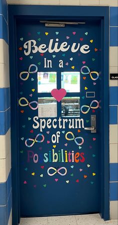 a blue door with the words believe in a spectrum of possibilities painted on it