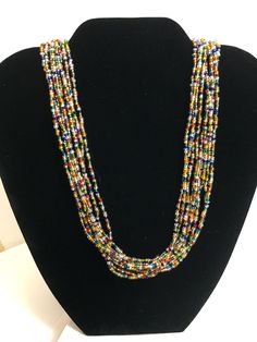 This multi strand beautiful elegant necklace features multi-color seed beads and silver magnetic clasp. It measures about 19 inches in length. All items come from a non-smoking and pet-free home. Fast and free shipping. Multicolor Double Strand Beaded Necklace With Large Beads, Multicolor Multi-strand Beaded Necklaces With Tiny Beads, Rainbow Multi-strand Beaded Necklaces, Multicolor Double Strand Necklace With Large Beads, Multicolor Tiny Beads Multi-strand Necklace, Multicolor Multi-strand Beaded Necklaces, Multicolor Small Beads Multi-strand Jewelry, Multicolor Multi-strand Tiny Beads Necklaces, Multicolor Multi-strand Necklaces With Tiny Beads