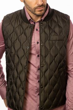 Olive Quilted Puffer Vest Introducing the Olive Quilted Puffer Vest from Stone Rose, a must-have for the fashion-forward man. Tailored for men aged 18 to 80, this vest is a versatile and stylish addition to your fall wardrobe, blending functionality with modern aesthetics. Designed with a warm quilted body and complemented by knitted side panels, this hybrid vest offers both comfort and flexibility. The easy-to-wear snaps and practical pockets enhance its functionality, making it a convenient ch Quilted Puffer Vest, Stone Rose, Rose A, Modern Aesthetics, Puffer Vest, Side Panels, Fall Wardrobe, Layering Pieces, Panel Siding