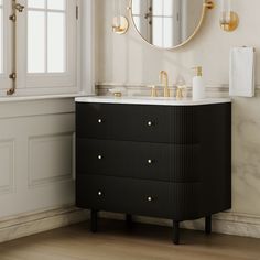 a bathroom vanity with two sinks and a round mirror