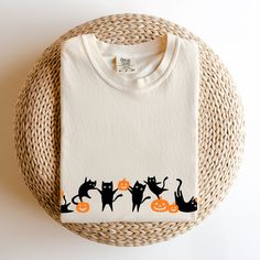 You'll love this ultra cute black cats autumn Halloween party inspired Tshirt. With its short sleeves, crew neck and comfy Comfort Colors fabric, it'll be your new fall fave tee this year. :D Let the witty kitty + cute pumpkin fun begin :P ABOUT * ADULT MEDIUM WEIGHT SHORT SLEEVE T-SHIRT / Comfort Colors 1717 Brand * Fabric: 100% cotton / Medium weight fabric (6.1 oz/yd² (206.8 g/m * Made with DTF (Direct to Garment Printing process) * Cozy + Relaxed fit / Double-needle stitching throughout / No Spooky Cat Print Crew Neck T-shirt, Fall Cotton T-shirt With Cat Design, Cotton T-shirt With Cat Design For Fall, Halloween Cat Print Crew Neck T-shirt, Spooky Cotton T-shirt With Cat Print, Black Cat Autumn, Cats Autumn, Black Cat Lover, Halloween Party Gifts