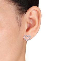 Express how much love means to you with the beautiful woven design of these diamond double heart stud earrings in sterling silver. Crafted in sterling silver Each earring showcases a pair of heart outlines in a layered and interwoven design. Diamonds and beaded details sparkle along half the look in a playful arrangement. Radiant with 1/5 ct. t.w. of diamonds These post earrings secure comfortably with friction backs. Silver Diamond Earrings For Valentine's Day, Valentine's Day Diamond Cut Heart Earrings, Heart-shaped Diamond Earrings Fine Jewelry, Heart Shaped Diamond Earrings Fine Jewelry, White Diamond Heart Earrings, Silver Heart Earrings For Anniversary On Valentine's Day, Valentine's Day Sterling Silver Diamond Cut Earrings, Fine Jewelry Double Heart Earrings With Diamond Accents, Diamond Open Heart Earrings For Valentine's Day