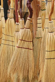 several brooms are lined up on the floor