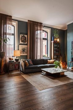 a living room filled with furniture and lots of windows