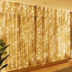 a living room filled with lots of lights next to a window covered in sheer curtains