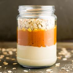 a jar filled with oatmeal and other food on top of a table