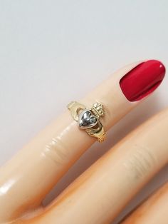 "Thanks for shopping our vintage estate store. We tend to sell well below wholesale and truly hope you enjoy all of our items. Many of the items are one of a kind, so please enjoy scrolling through the pictures and hopefully something will catch your eye. Blacks spots are from camera or reflections. Beautiful estate 14k gold yellow white gold Irish Claddagh infant or baby ring. Retails $299 on sale $149 Ring size: 1 Setting: 3/8\" 8.5mm Band width: 2mm Weight: .1.07 grams Beautiful ring, one tha Vintage Gold Heart Ring With Birthstone, Heirloom Heart Ring With Hallmark, Heart Cut Hallmarked Collectible Jewelry, Collectible Gold Rings With Birthstone, Irish Heart, Beach Rings, Baby Ring, Irish Claddagh, Baby Rings